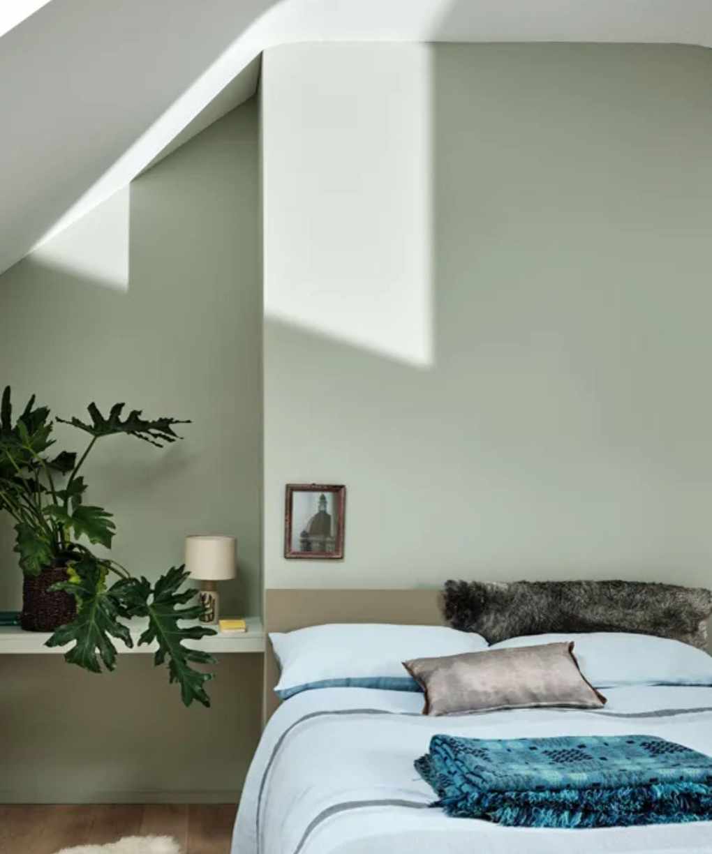 A cozy bedroom with plants and natural light