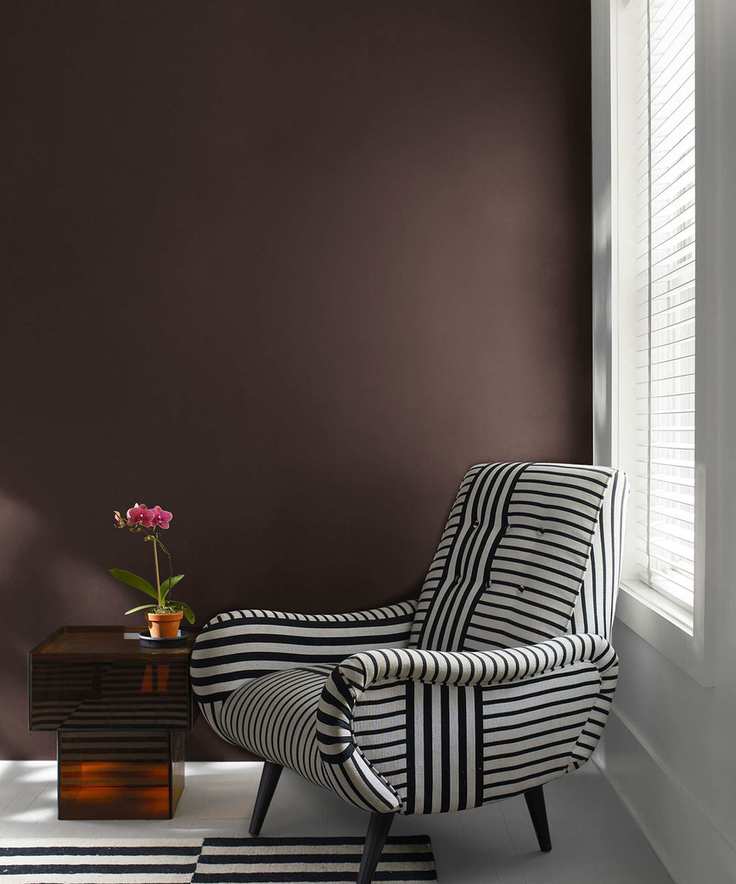 black and white armchair against a dark wall