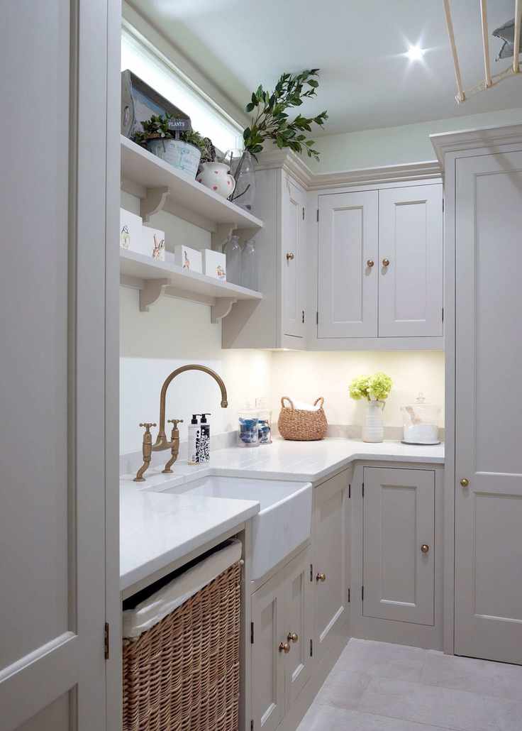 Fitted cabinetry in a small laundry room with white countertops.