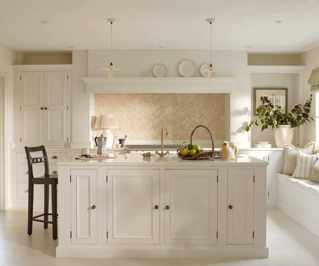 A white kitchen with a large kitchen island that utilizes storage on both sides