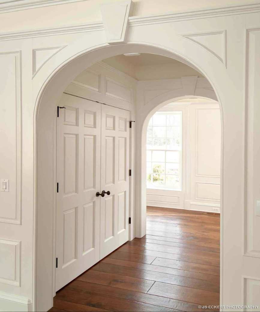 A built-in closet in an archway by Melichar Architects