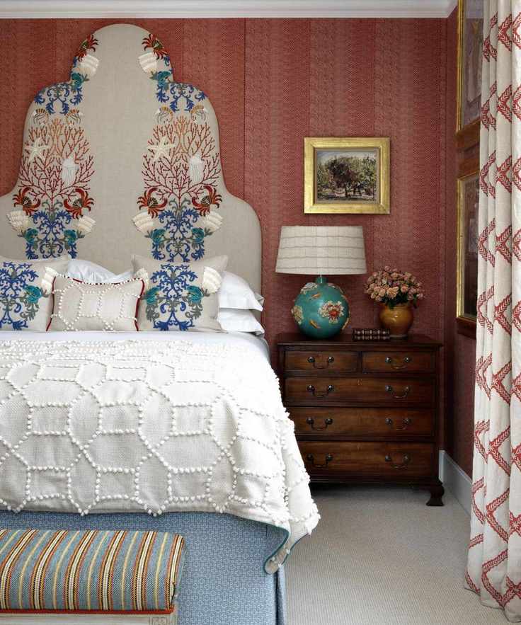 Colorful bedroom with pattern and ornate headboard in Kit Kemp's house