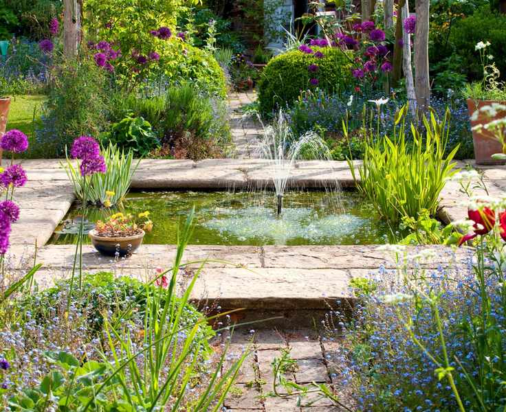 garden fountain in a wildlife pond in a country garden