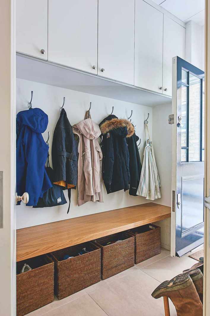 boot room with bench, hooks and overhead lockers