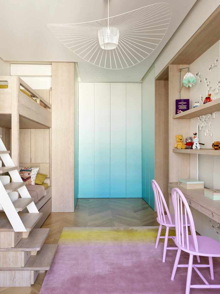 Blonde wood children's twin bedroom with bunks and wall storage