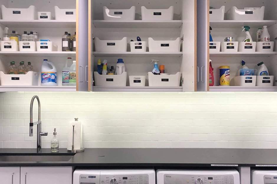 Laundry room with cabinets and countertop and shelves above