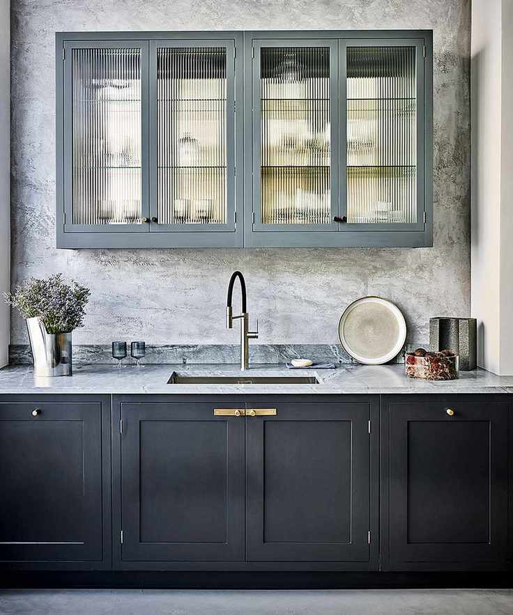 Modern kitchen with dark cabinets and fluted glass