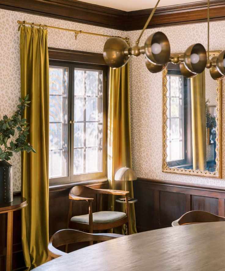 modern dining room with modern light fixture and contrast curtains