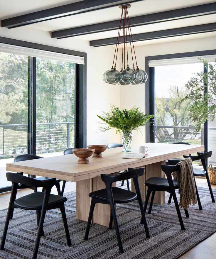 Neutral dining room with large windows