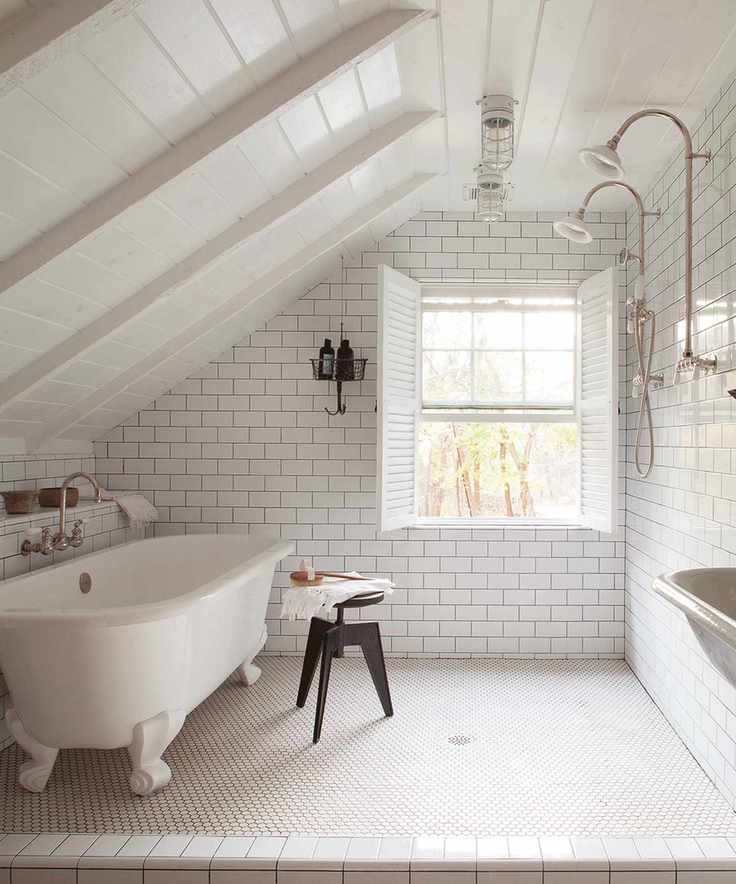 Wet room with freestanding bath and sloping ceiling