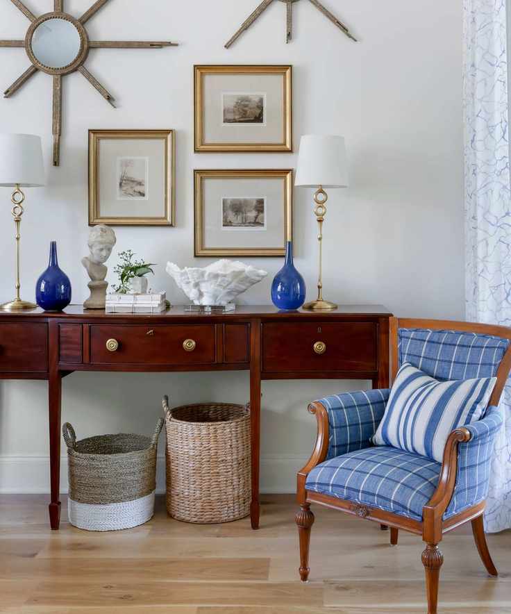 wooden dresser with traditional armchair and gallery wall