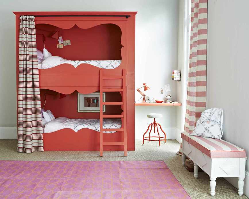 A warm bunk bed with a curtain and soft rug