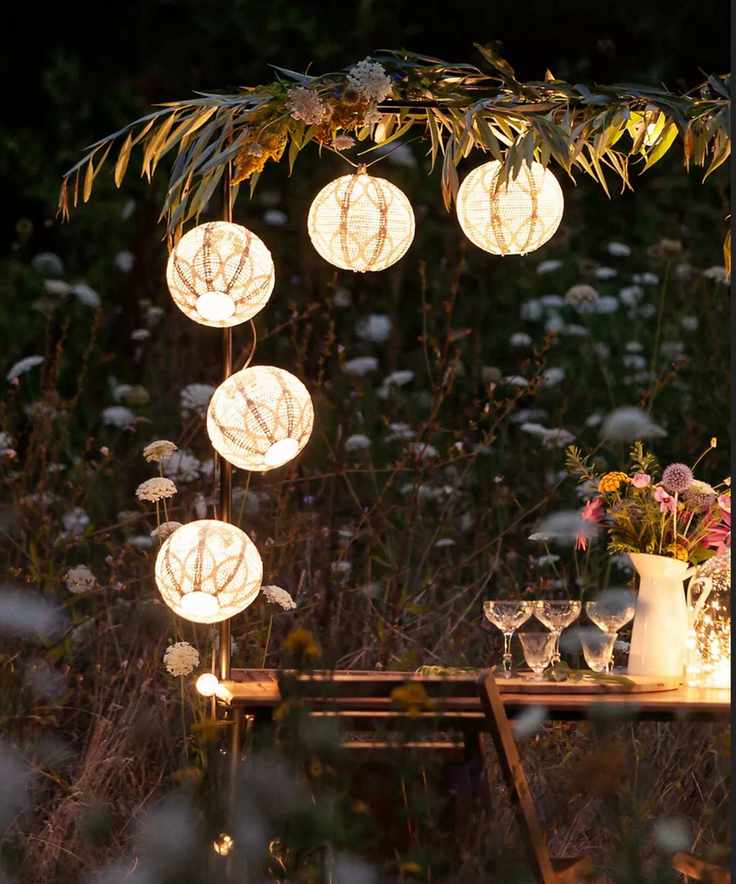 Table with glasses lit up by lanterns