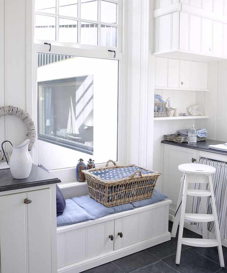 Laundry room with a storage bench for functional use and comfort.