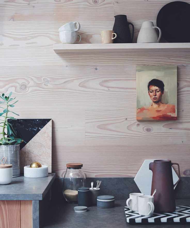 A modern kitchen with coffee supplies and mugs out