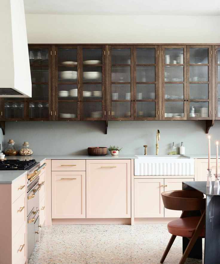 Modern farmhouse kitchen with glass fronted cabinets, farmhouse sink and creamy neutral colored paint