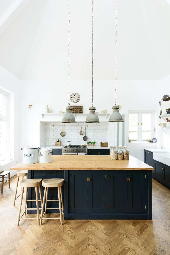 Kitchen with blue cabinets and island with wood countertop