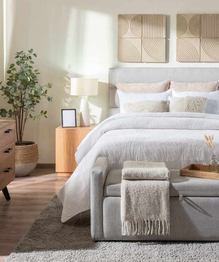 Bright bedroom with grey bed and decor