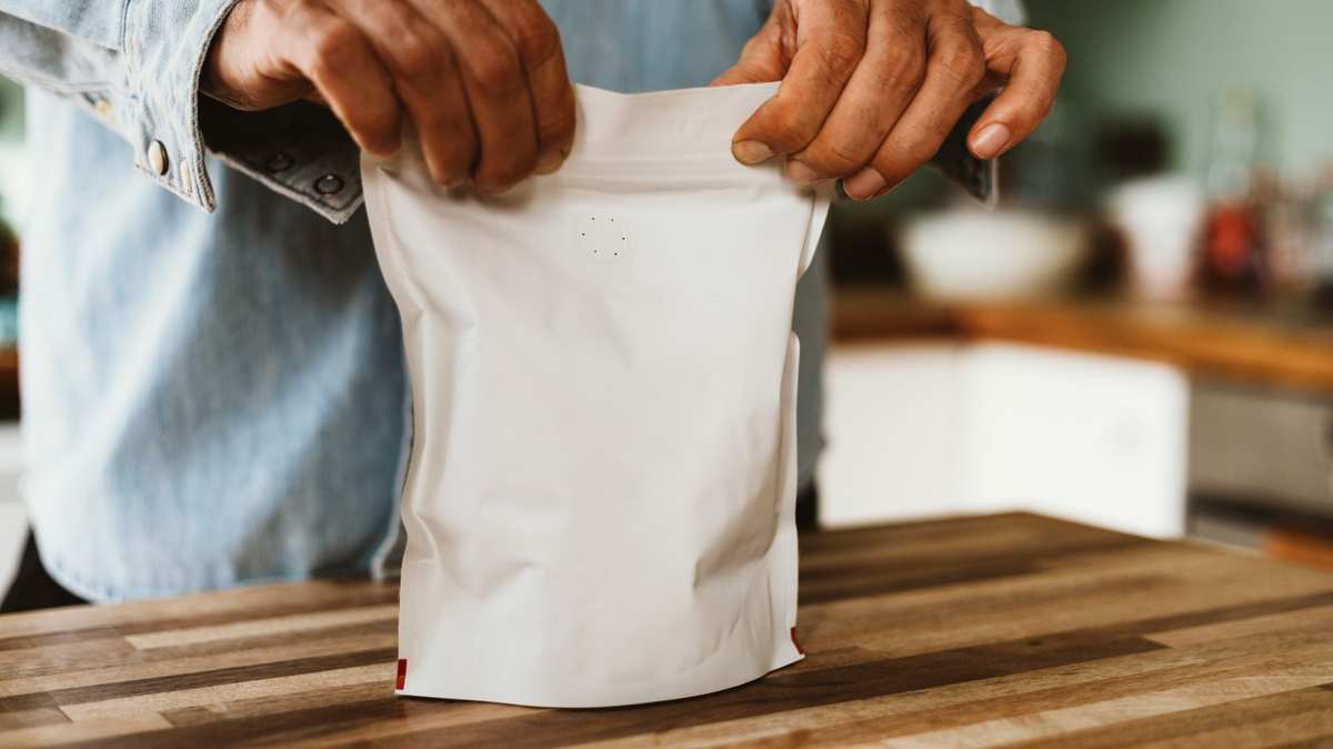 A bag of coffee beans being sealed