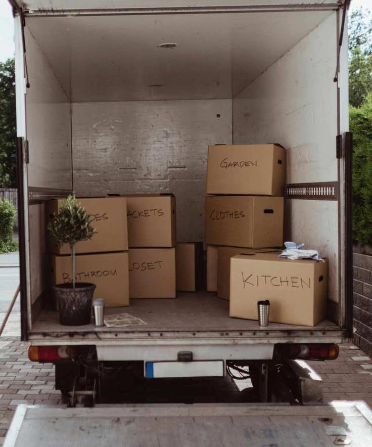 A moving van loaded with labeled boxes