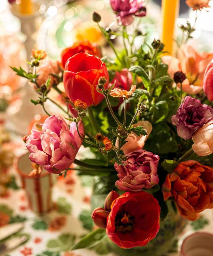 A close-up shot of a vibrant floral arrangement with tulips and wildflowers