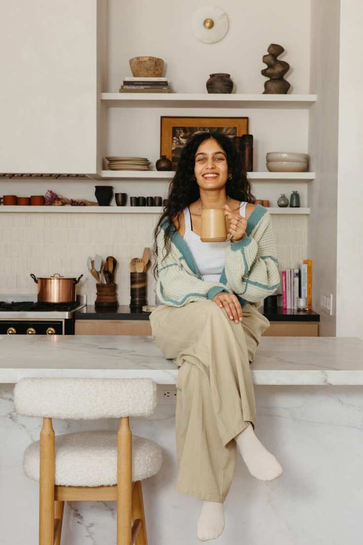 Woman drinking coffee in kitchen