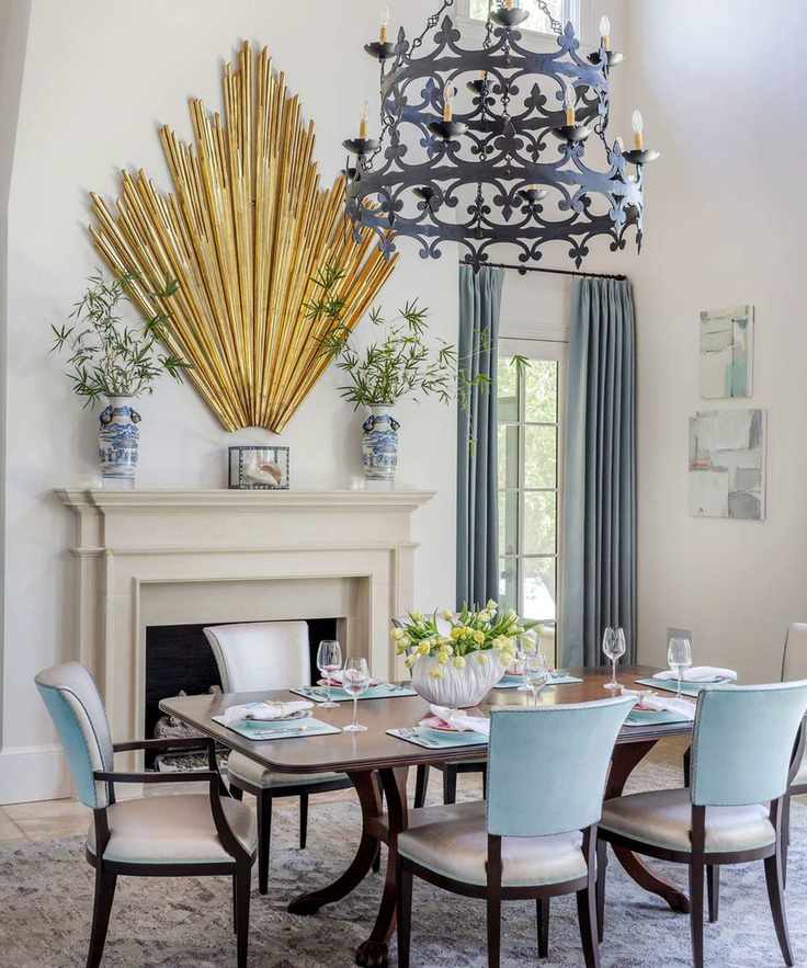 Formal dining area with wooden dining table, large stone fireplace