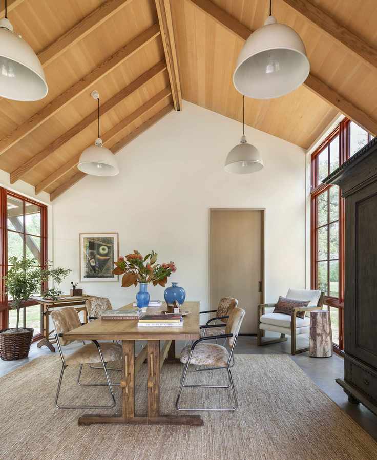 Modern dining room with wood panelled ceiling and retro furniture