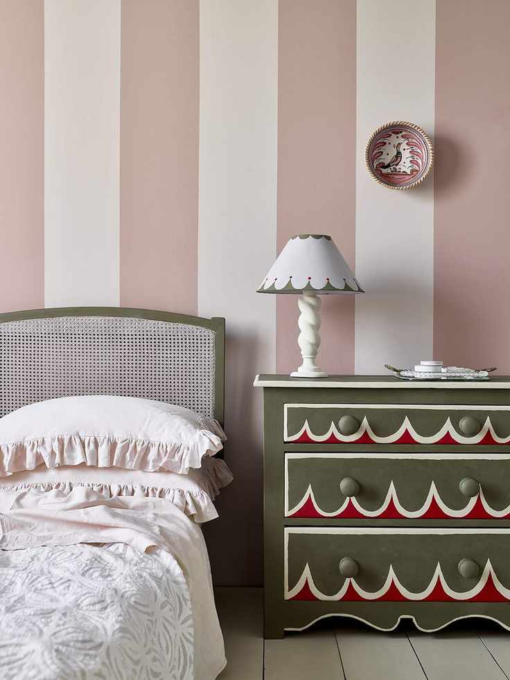 Bedroom with nightstand and striped wall