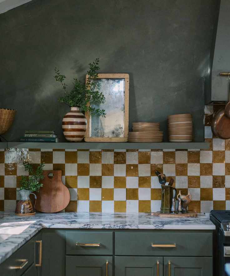 A rustic kitchen showcasing dark green walls and cabinetry.