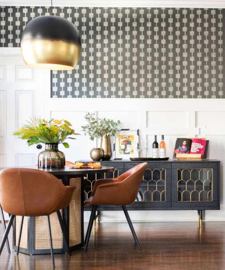 A dining room with brown leather chairs and a large black console