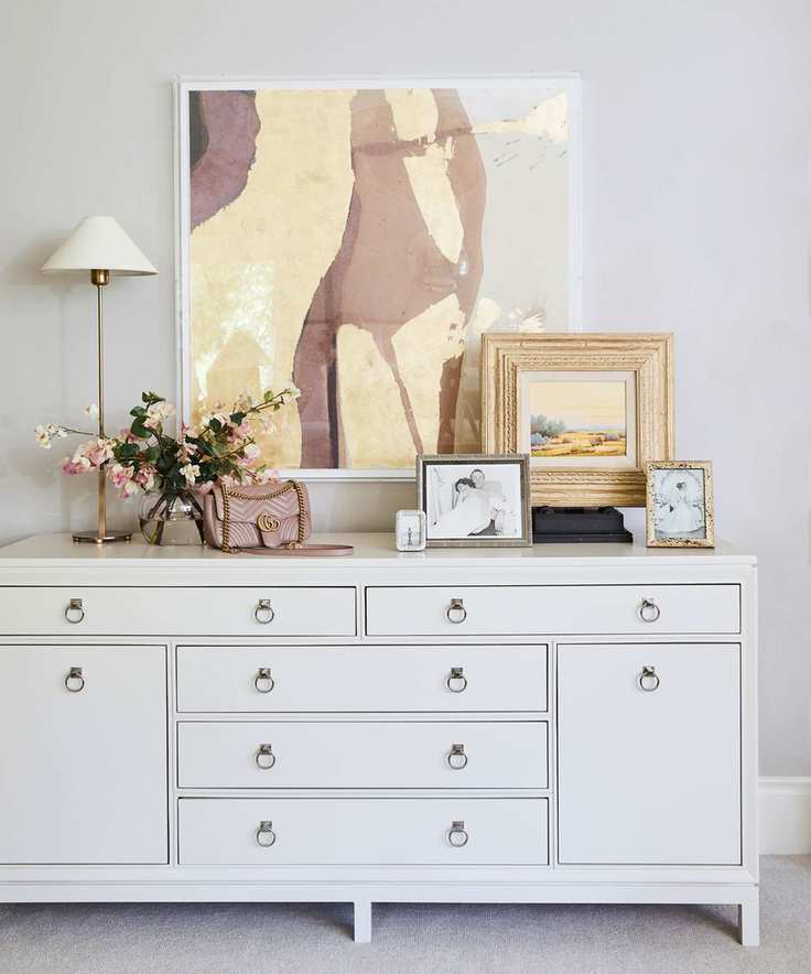 Corner of a bedroom with decorative items and artwork
