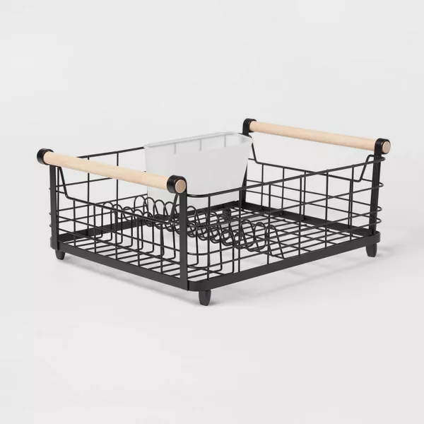 A black metal Dish Rack with wooden handles.
