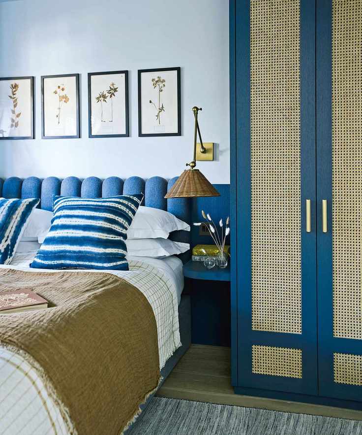 Pale blue bedroom with themed artwork above the bed