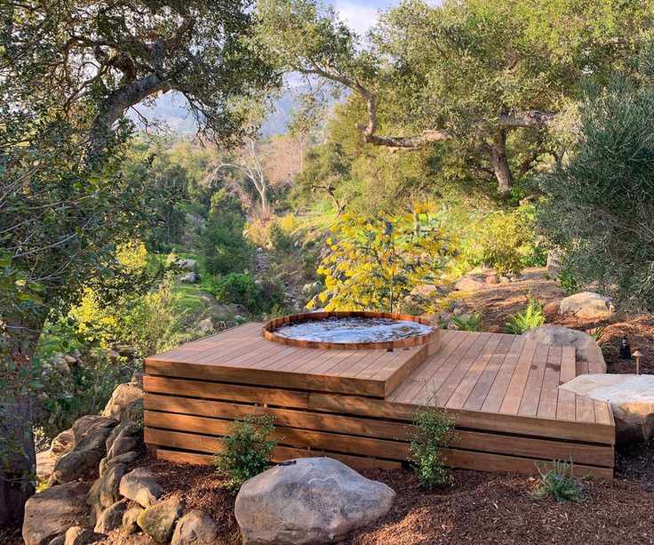hot tub built into a secluded timber deck
