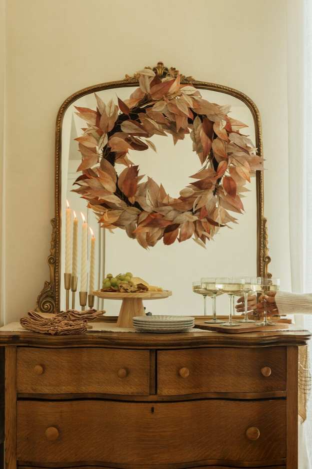 Stylish fall evergreen wreath on a buffet table.