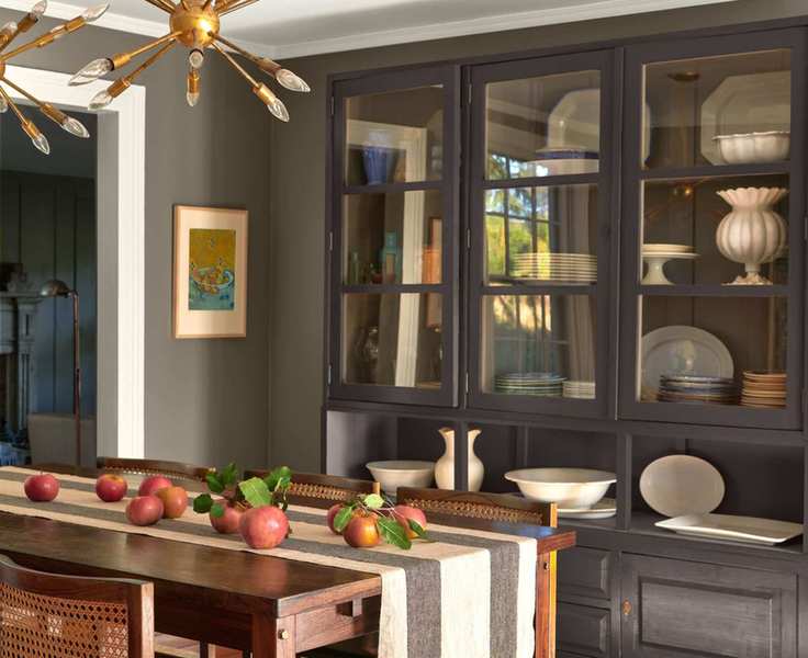 kitchen with taupe walls, large dark wood dresser, wooden table with chairs