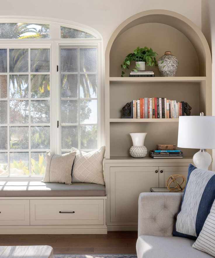 Living room with built in alcove storage painted in light brown