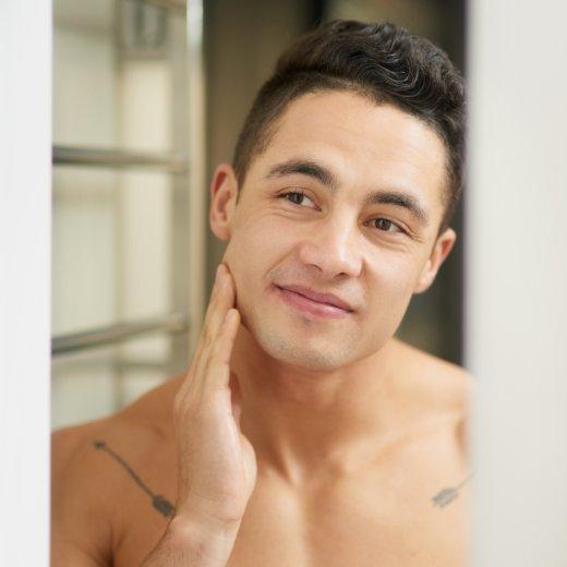 Man touching his face after daily skincare routine