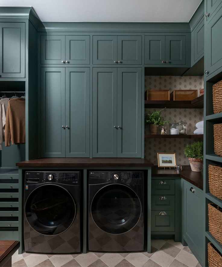 A laundry room with a black washer and dryer set, checkered floors, and wicker baskets