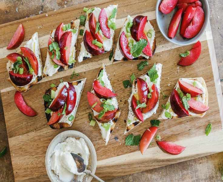 ricotta and plum bruschetta on serving board