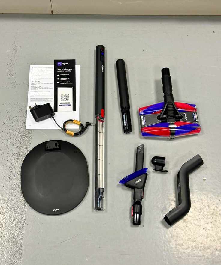All components for the Dyson PencilVac Fluffycones displayed on a gray floor.