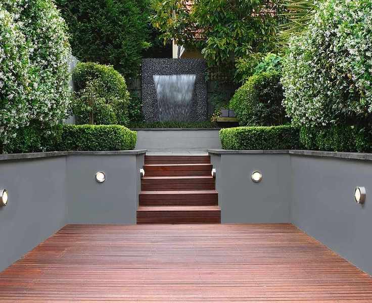 split level garden with decked area and steps with integral lighting design