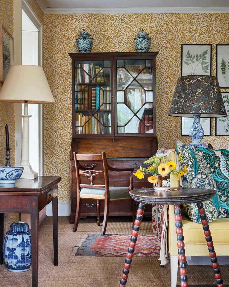 Morris & Co wallpaper in a living room with a large glass fronted dresser