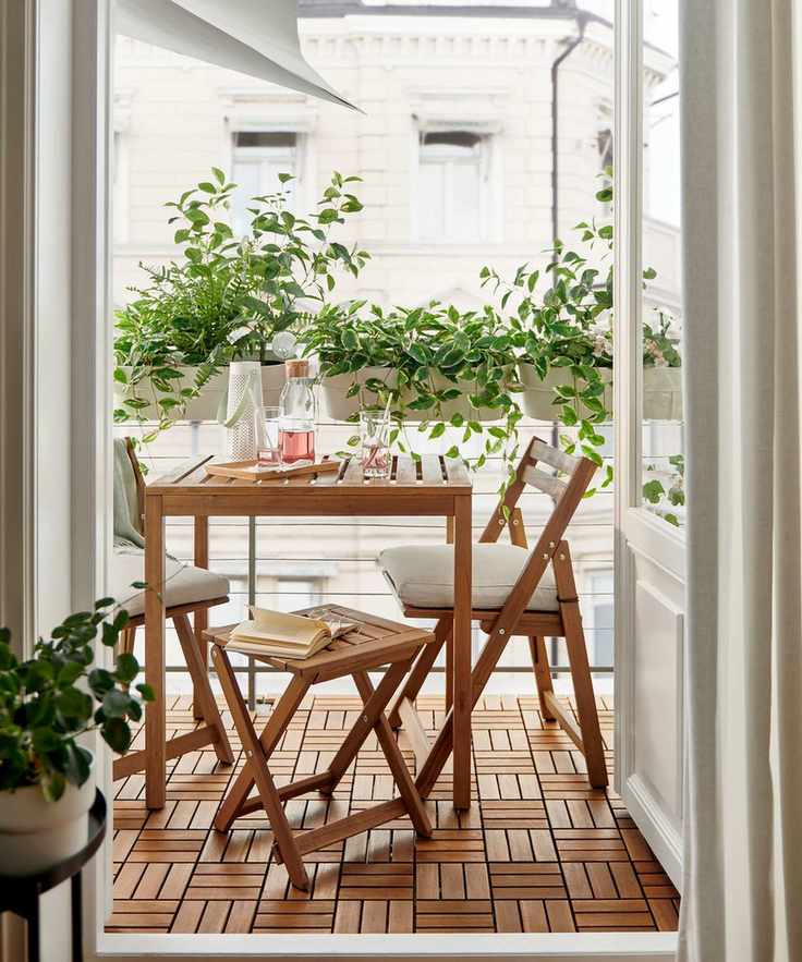 small balcony with white balcony planters