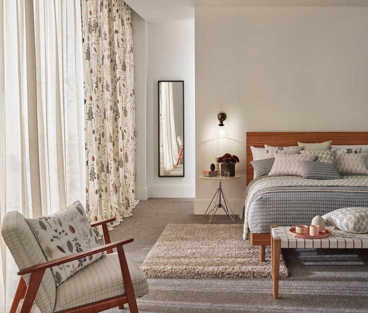 bedroom with sheer drapes and floral curtains