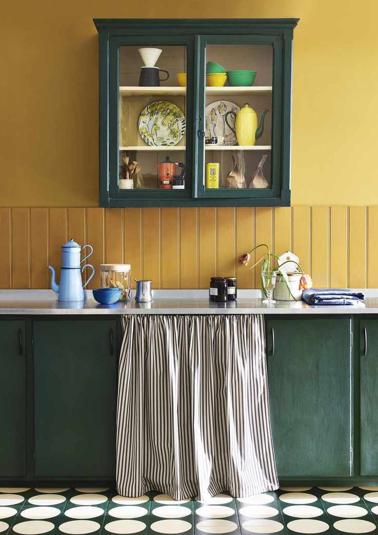Annie Sloan yellow kitchen with green cabinets and painted tile floor