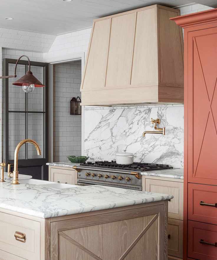 Kitchen with island, stove and marble