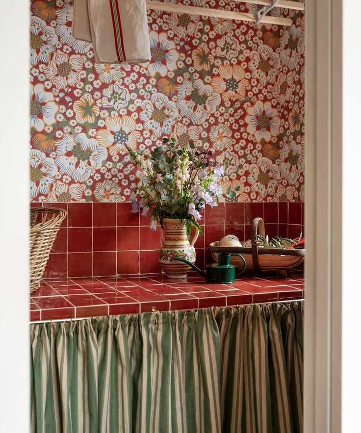 Laundry room with floral wallpaper and red tiles