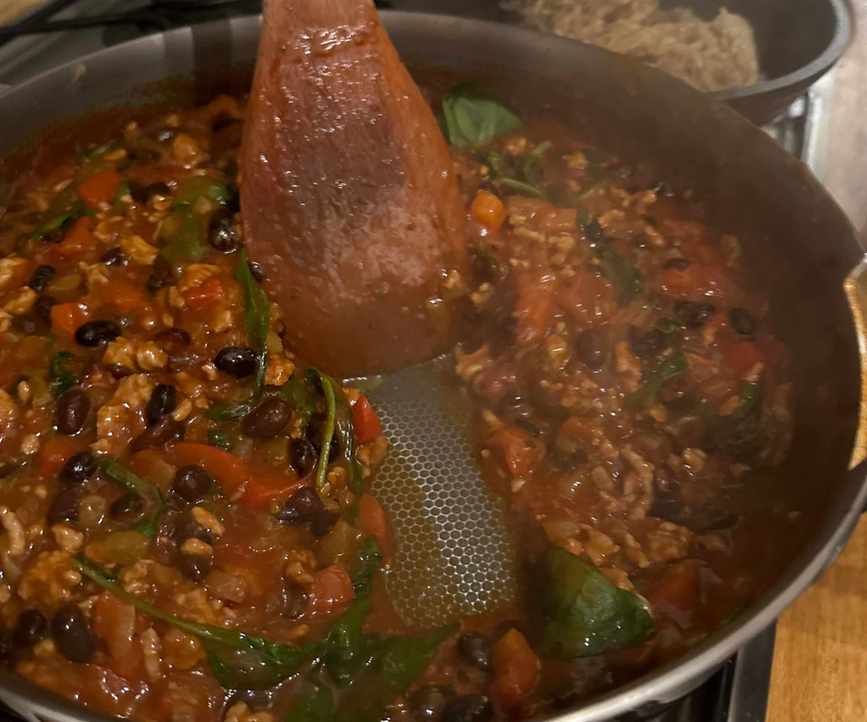 Our Place Titanium Always Pan Pro sizzling onions, chilli and steaks in the kitchen 